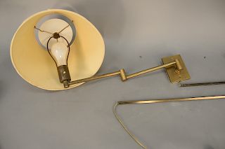 Four Hansen brass articulating wall mount lamps with shades.