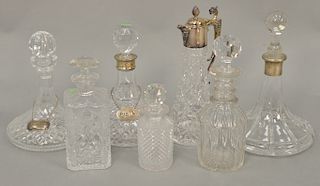 Seven crystal carafes with stoppers to include Waterford. 