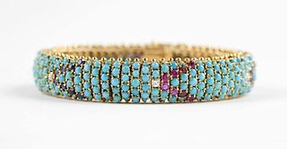 A turquoise, ruby and sapphire gold bracelet