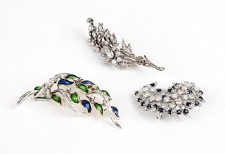 A collection of three diamond brooches