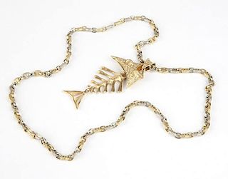 A gold fish pendant on long chain