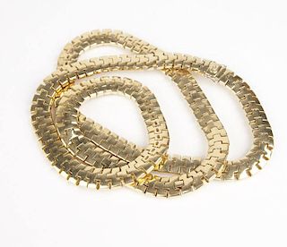 A three row gold link long necklace