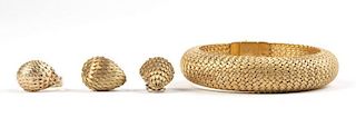 A gold bracelet, earclips and ring