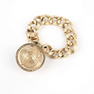 A gold large link charm bracelet with globe charm