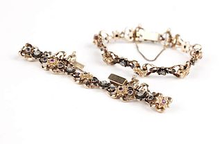 A pair of gold and gem-set bracelets
