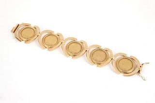 A gold bracelet set with five British gold coins