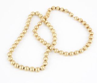 A group of two gold bead necklaces