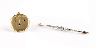 A diamond and gold bar pin