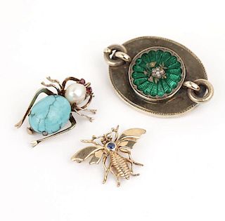 A group of three gem, enamel and gold brooches