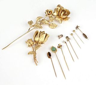 A collection of stick-pins and brooches