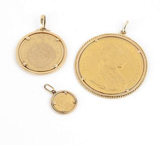A group of three gold coin pendants