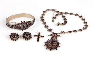 A collection of garnet, gold and metal jewelry