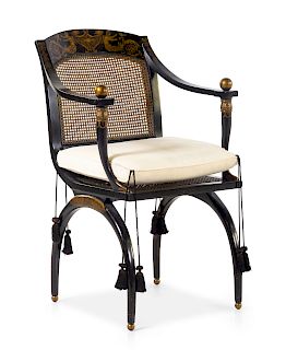 An Italianate Parcel Gilt and Ebonized Armchair<b