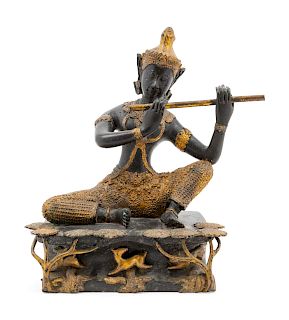 A Thai Gilt and Patinated Bronze Flute Player<br>