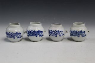 Four Chinese blue and white porcelain bird feeders.