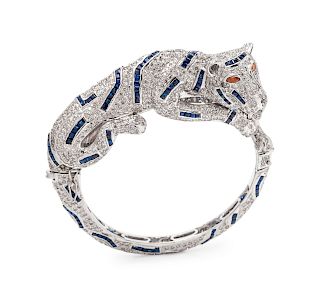 A White Gold, Diamond and Sapphire Panther Motif Bangle Bracelet,
