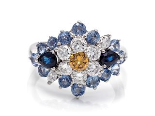 An 18 Karat White Gold, Colored Diamond, Diamond and Sapphire Ring,