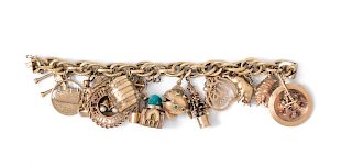 An 18 Karat Yellow Gold Charm Bracelet with 16 Attached Charms,