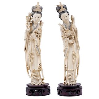 LADIES WITH FLOWERS. CHINA, 20TH CENTURY.   A pair of carved ivory models with ink details.