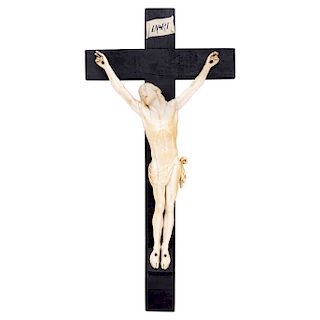 CHRIST CRUCIFIED. FRANCE, 19TH CENTURY. Carved ivory figure with ink details on a wooden crucifix (from a later stage). 