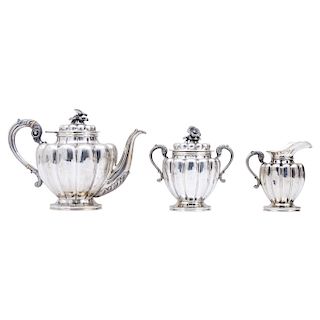 TEA SERVICE. MEXICO, 20TH CENTURY.  Sterling 0.925 Silver. The body with repoussé and chased strapwork. Comprising a teapot, a sugar bowl and a cream 