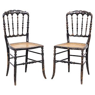 A PAIR OF CHAIRS. ENGLAND, CIRCA 1900. Victorian Style. Ebonised wood with mother-of-pearl and hand-painted details. Cane seats.