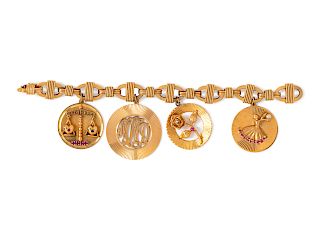 A 14 Karat Yellow Gold Bracelet with 4 Attached Charms,