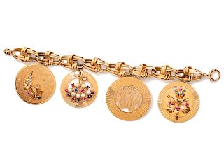 A 14 Karat Yellow Gold Charm Bracelet with Four Attached Charms,