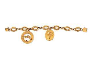 A 14 Karat Yellow Gold Bracelet with Two Attached Charms,
