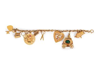 A 14 Karat Yellow Gold and Multigem Charm Bracelet,