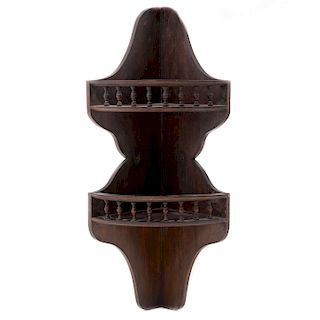 Peana-esquinero. Siglo XX. Elaborada en madera tallada.  A 2 niveles. Decorada con escalonados y barandillas.