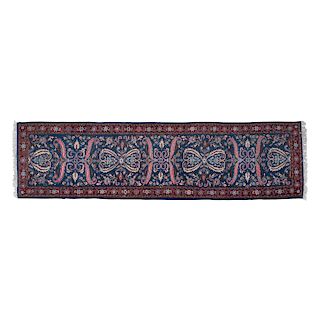 Tapete de pasillo. Irán, Siglo XX. Anudado a mano en fibras de en lana. Decorado con motivos orgánicos en tonos rojo y hueso.