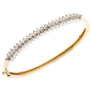 A diamond 14K yellow gold bangle bracelet.