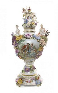 A German Porcelain Urn, Cover and Stand, Height overall 22 3/4 inches.