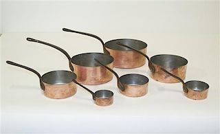 A Set of Seven Copper Pots, Diameter of largest 7 inches.