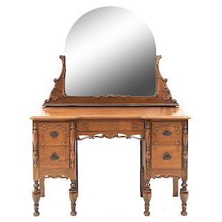 Tocador. Siglo XX. En talla de madera. Con espejo de luna irregular y 5 cajones con tiradores de metal. 157 x 117 x 46 cm.