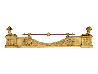 A Pair of Empire Gilt Bronze Chenets and a Fireplace Fender