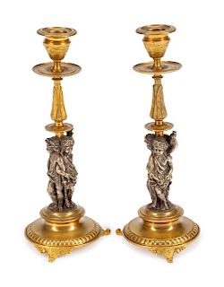 A Pair of French Gilt and Silvered Bronze Figural Candlesticks