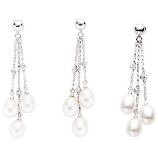 Pendiente y par de aretes con perlas y diamantes en oro blanco de 14k. 9 perlas cultivadas oval. 9 acentos de diamantes. Peso:...
