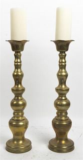 * A Pair of Brass Candlesticks, Height 21 inches.