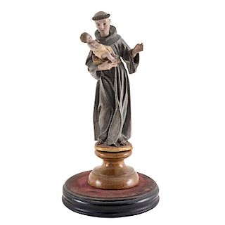 SAINT ANTHONY OF PADUA. MEXICO, CIRCA 1900. Carved and polychromed wood figure, decorated with glass eyes. With two wooden bases and glass cover. 