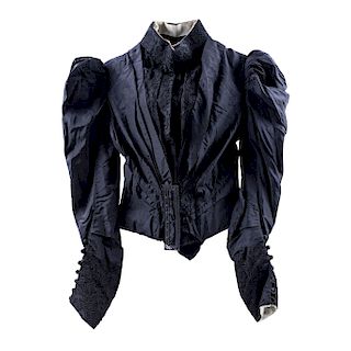 BLAZER AND UMBRELLA. CIRCA 1900. The black blazer with a rigid bodice (corset-like structure), a standing collar and embroided details. The umbrella m