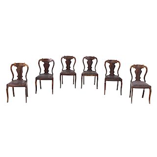 CHAIRS.XX CENTURY. Made of carved wood. Semi-open backs, seats in brown leather. Pieces: 5.
