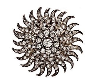 A Silver Topped Gold and Diamond Sunburst Pendant/Brooch, 11.30 dwts.