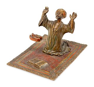 An Austrian Cold-Painted Bronze Figure of a Kneeling Man Praying on a Carpet