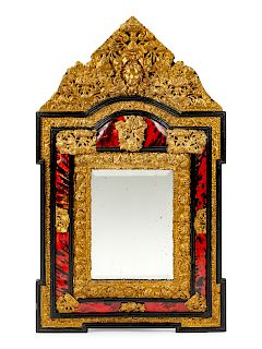 A Flemish Baroque Style Repouseed Brass and Ebony Mirror