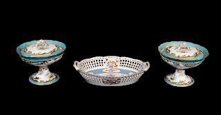 A Pair of 'Sevres' Porcelain Sauce Compotes and Covers and a Sevres Style Reticulated Porcelain Basket