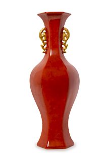 A Red Glazed Porcelain Double Handled Faceted Vase
Height 14 1/4 in., 36 cm.