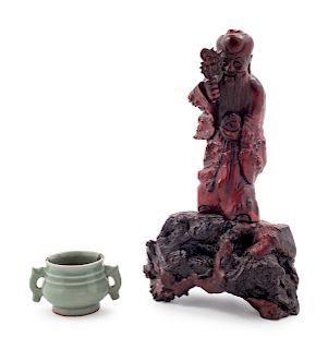 A Small Celadon Glazed Porcelain Incense Burner
Figure: height 10 1/2 in., 27 cm. Incense burner: height 1 7/8 x diam 2 1/8 in., 5 x 5 cm. 