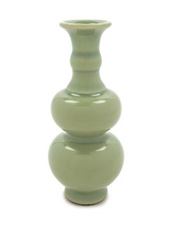 A Small Celadon Glazed Porcelain Gourd-Form Vase
Height 8 1/2 in., 22 cm.
